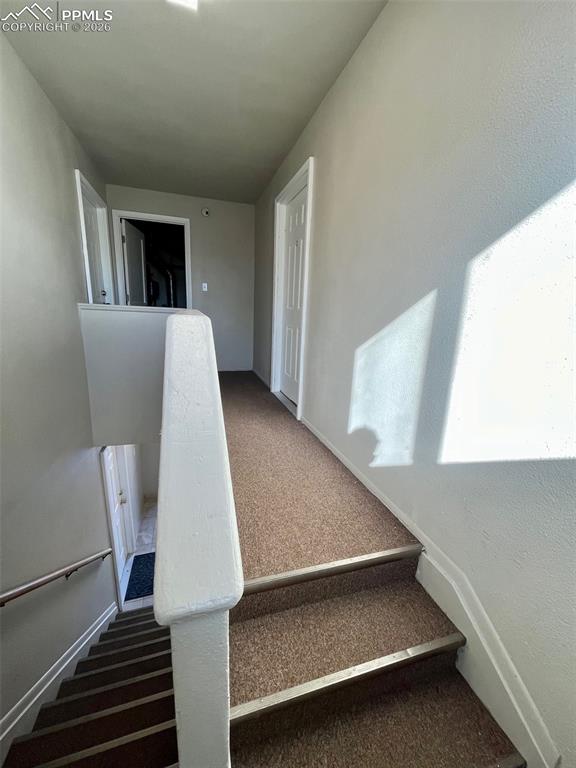 Image 11 of 26: Hallway to two upper units and laundry room.