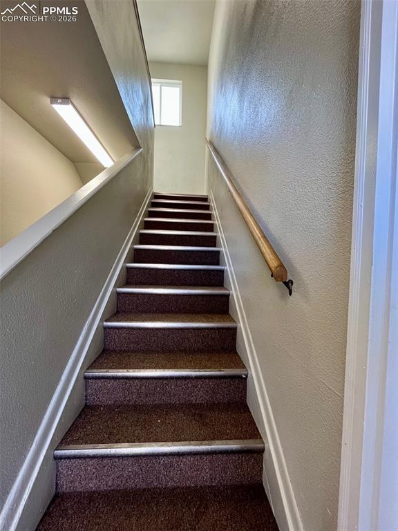 Image 9 of 26: Stairs leading to upper level.