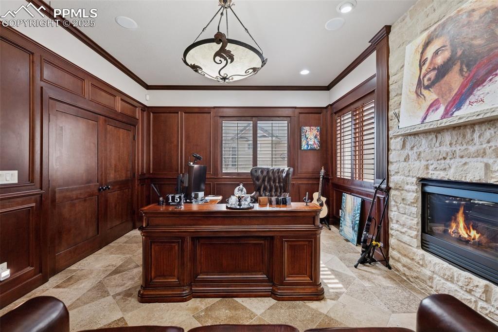 Image 20 of 48: Office space with a stone fireplace, recessed lighting, and crown molding