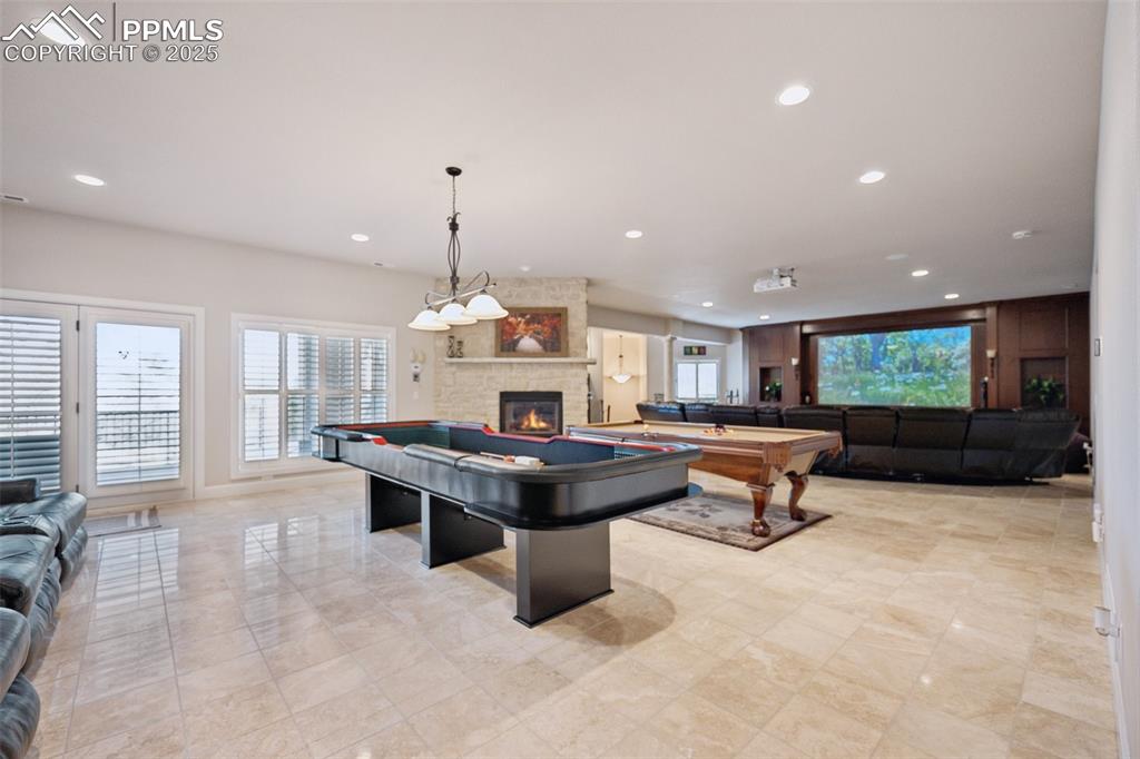 Image 33 of 48: Recreation room featuring recessed lighting, pool table, and a fireplace