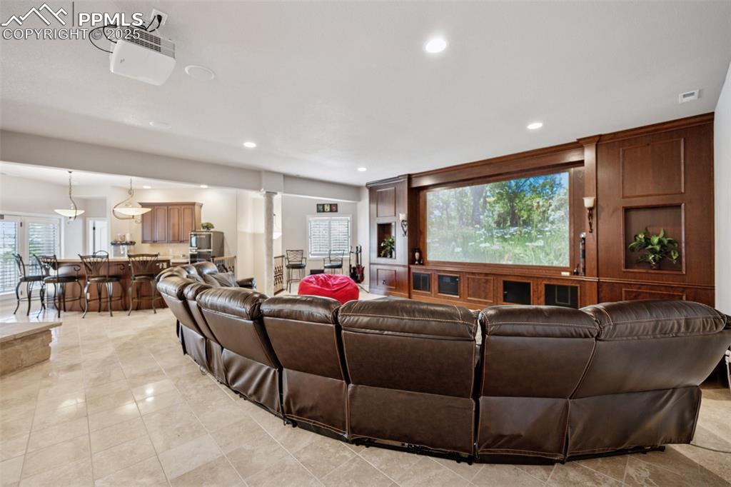 Image 35 of 48: Living room with recessed lighting, visible vents, light tile patterned flo