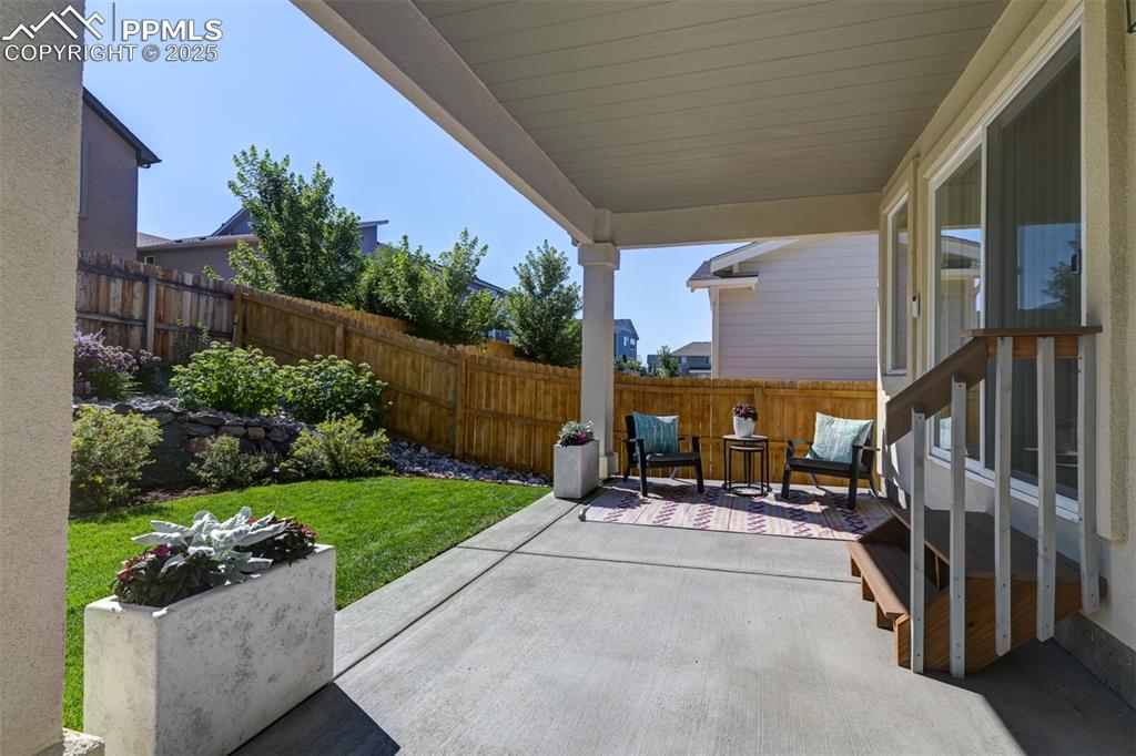 Image 6 of 44: Fenced backyard featuring a patio