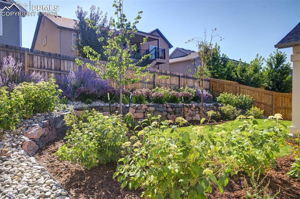Image 7 of 44: View of fenced backyard