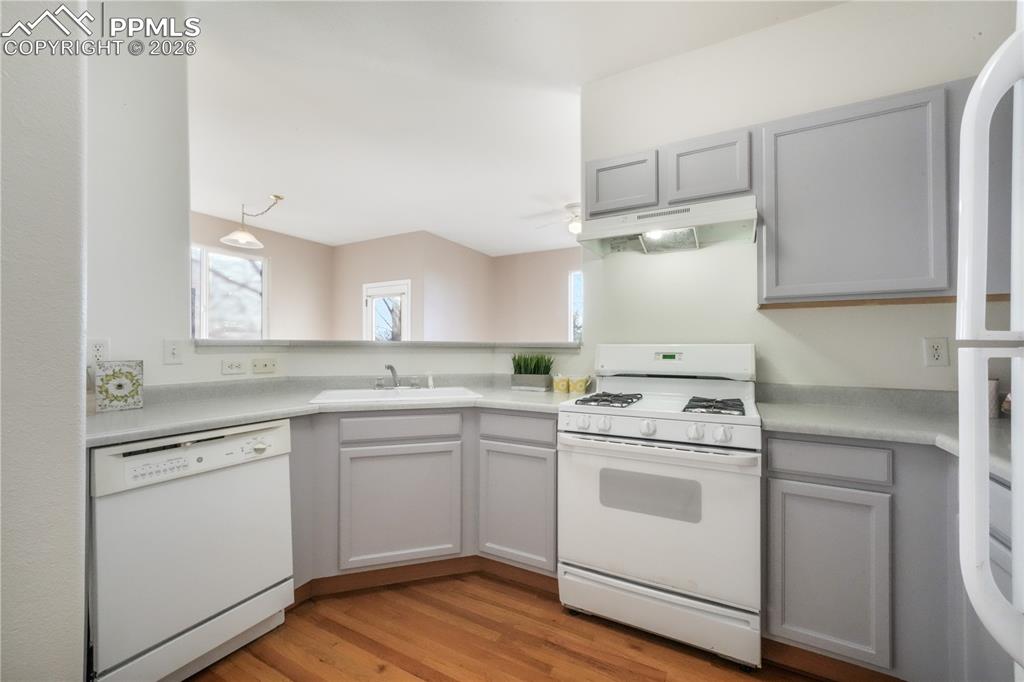 Image 16 of 50: Kitchen with gas stove and access to garage