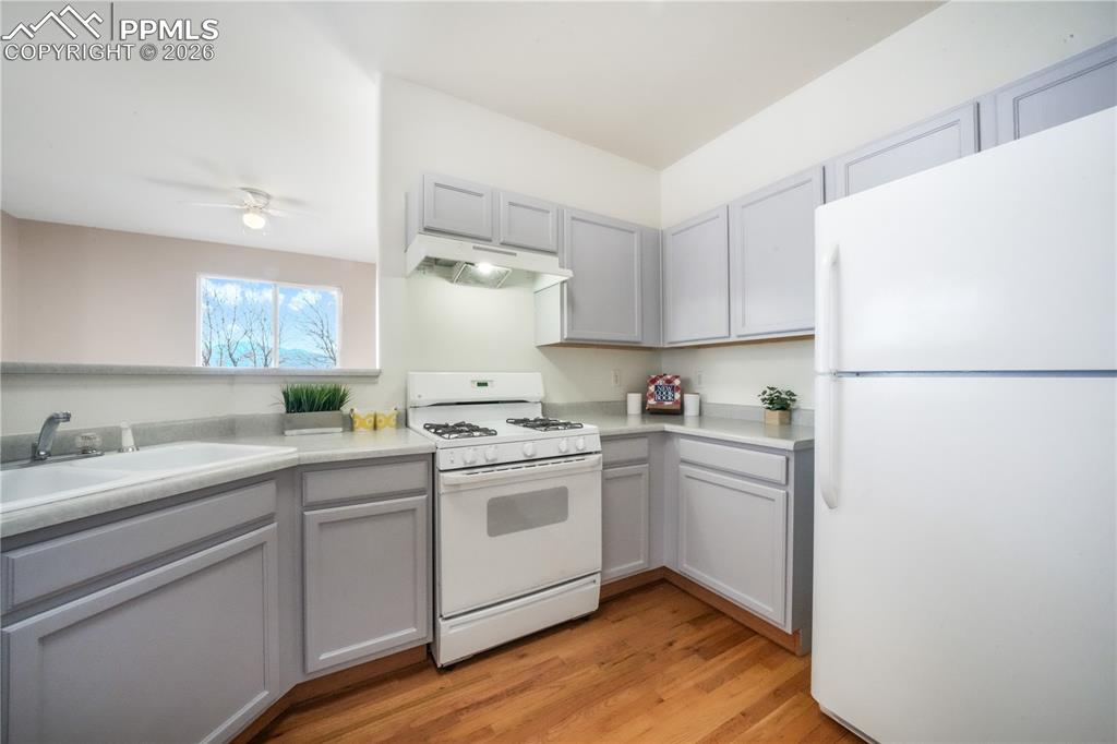 Image 18 of 50: Kitchen with gas stove and access to garage