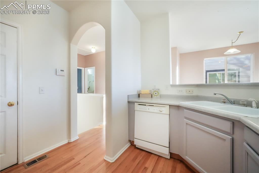 Image 19 of 50: Kitchen with gas stove and access to garage