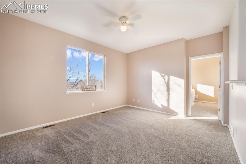 Image 20 of 50: Open concept living room looking to primary bedroom access