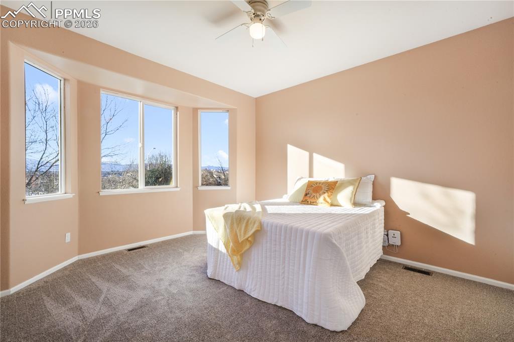 Image 21 of 50: Main level primary bedroom with ensuite bathroom