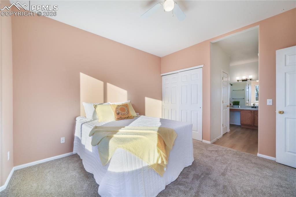 Image 22 of 50: Main level primary bedroom with ensuite bathroom
