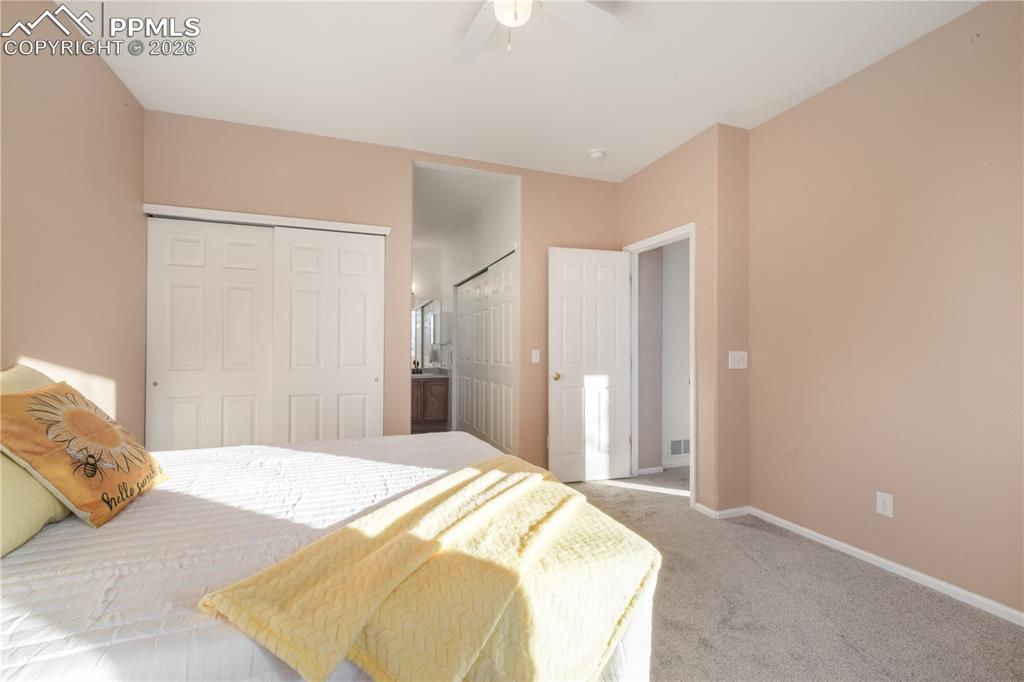 Image 23 of 50: Main level primary bedroom with ensuite bathroom