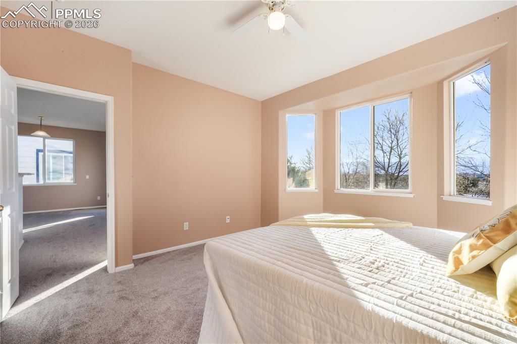 Image 24 of 50: Main level primary bedroom with ensuite bathroom