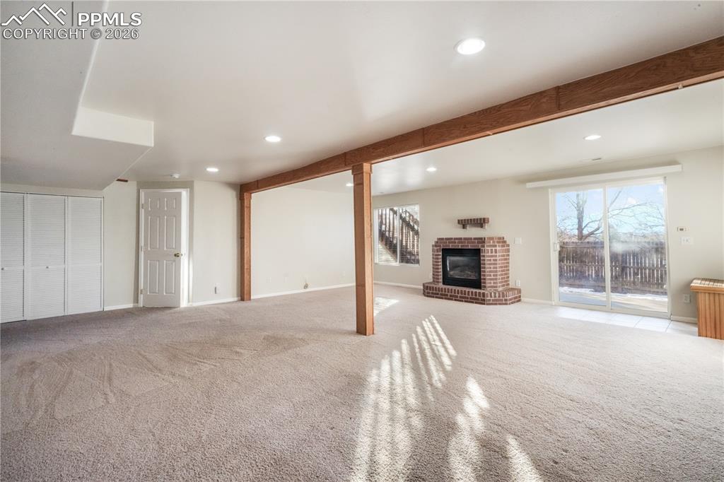 Image 33 of 50: Walk out basement family room with gas fireplace and access to back yard