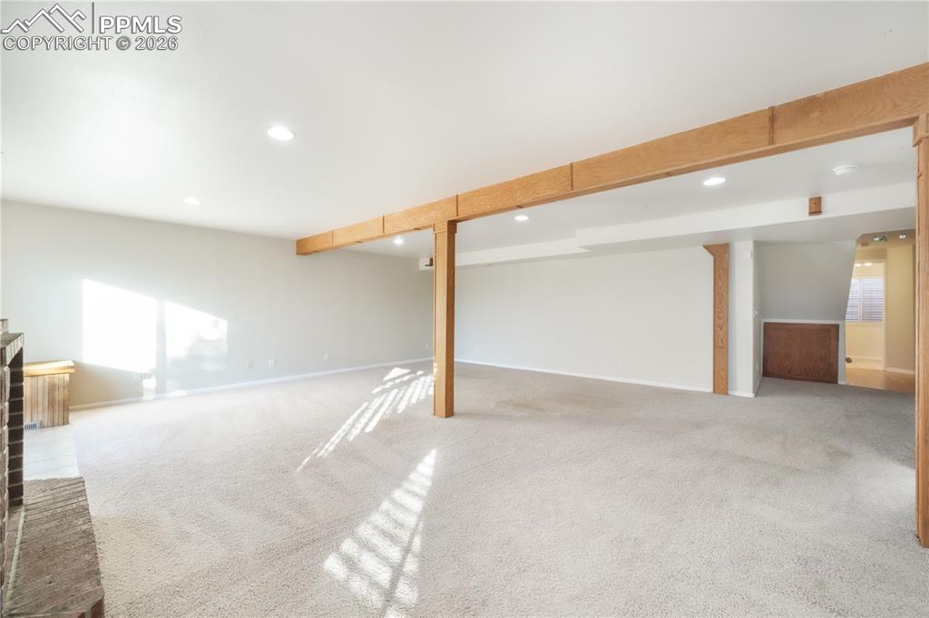 Image 34 of 50: Walk out basement family room with gas fireplace and access to back yard