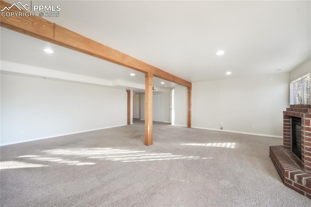 Image 35 of 50: Walk out basement family room with gas fireplace and access to back yard