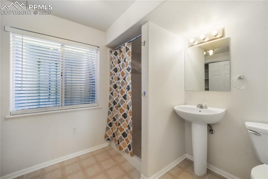 Image 39 of 50: Basement level 3/4 bathroom with large storage closet