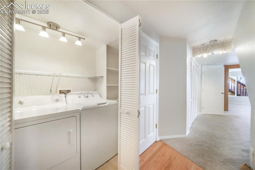 Image 41 of 50: Basement level laundry room with washer and dryer included