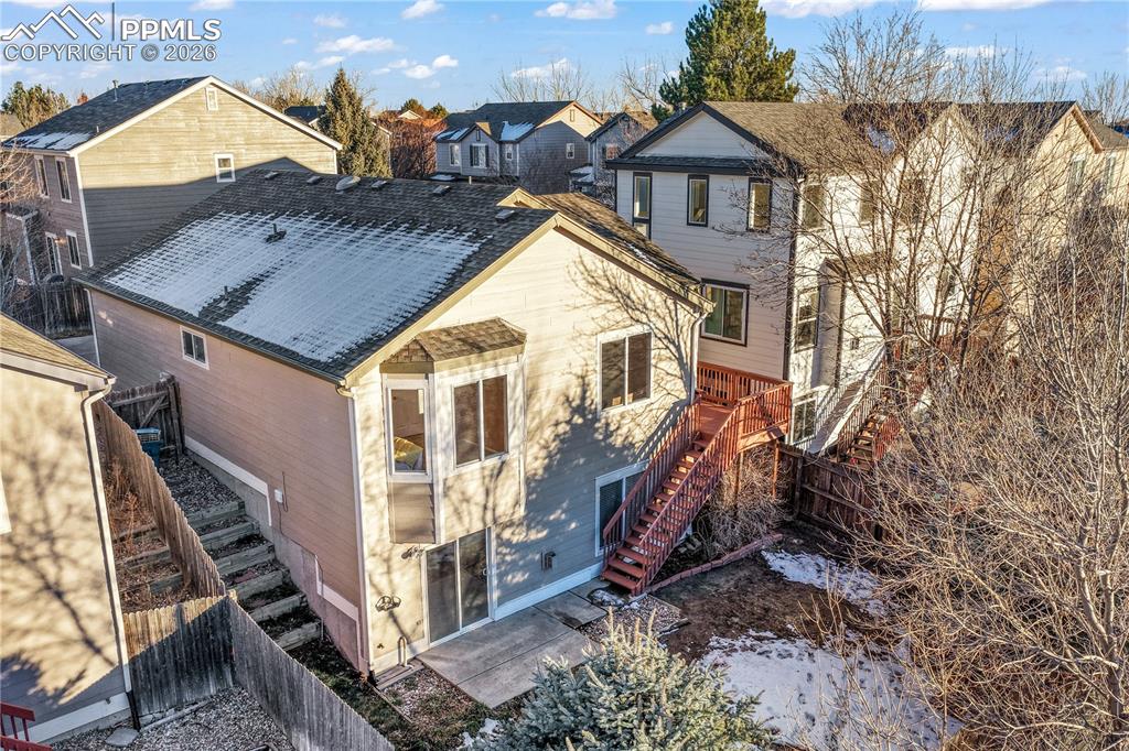 Image 46 of 50: Walk out basement from family room, large yard with privacy wood fence and 