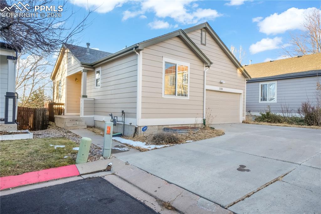Image 48 of 50: Front of home with 2 car garage and extra parking 