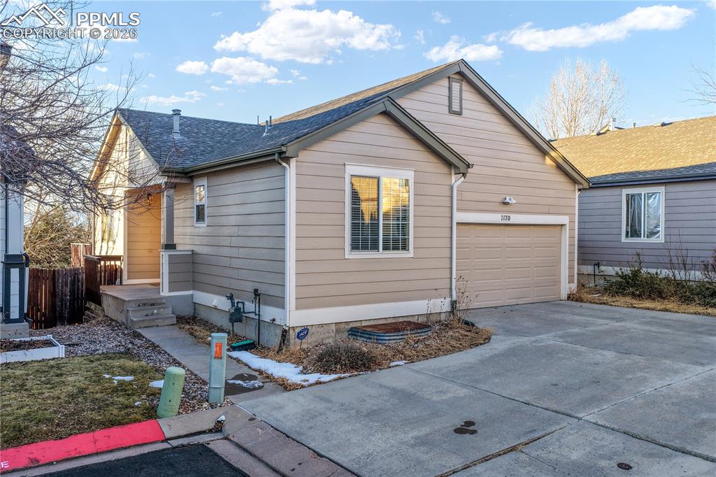 Image 6 of 50: Front of home with 2 car garage and extra parking