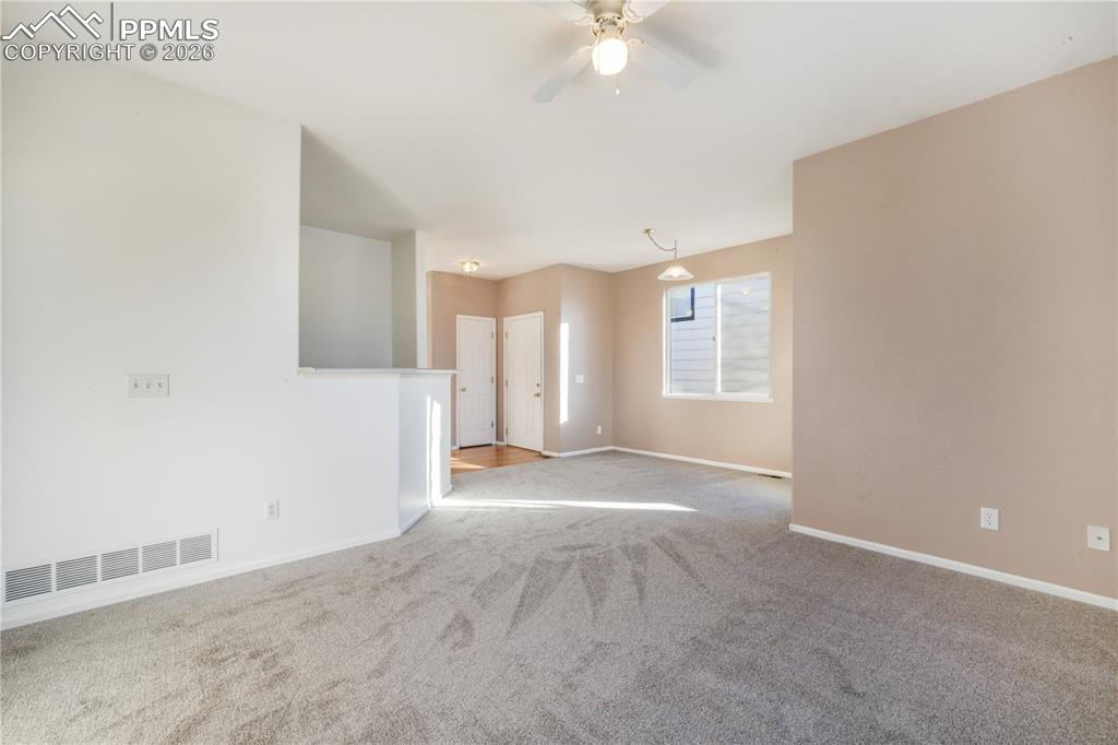Image 8 of 50: Open concept living room and dining area with access to to back yard and wa