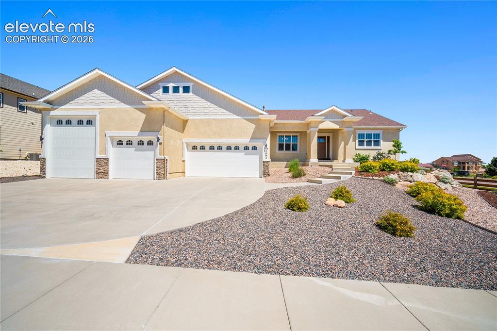 Caption: Stucco exterior, covered front porch, 4 car garage plus RV