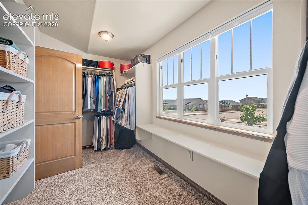 Image 18 of 44: Walk in closet with a wall of windows for natural light.