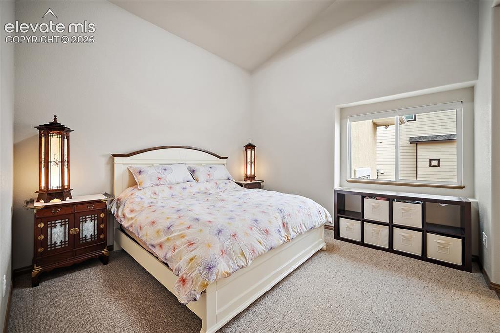 Image 24 of 44: Main level bedroom, vaulted ceilings