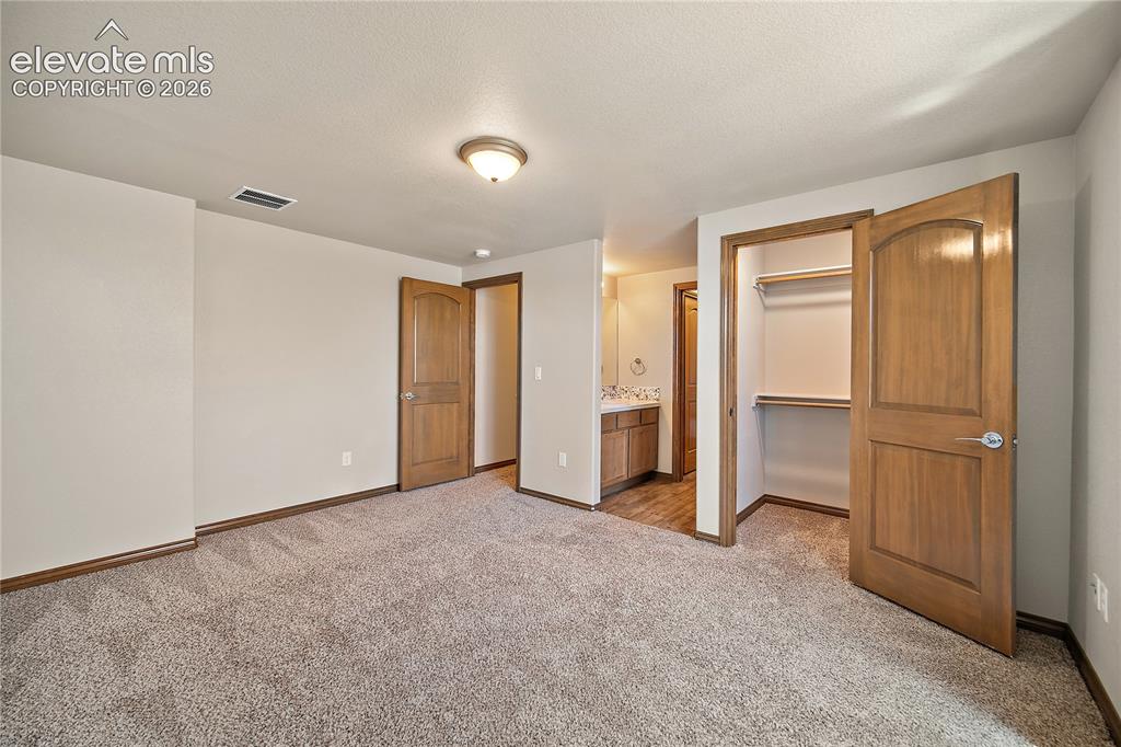 Image 30 of 44: Basement bedroom also with walk in closet and attached Jack n Jill bath. 