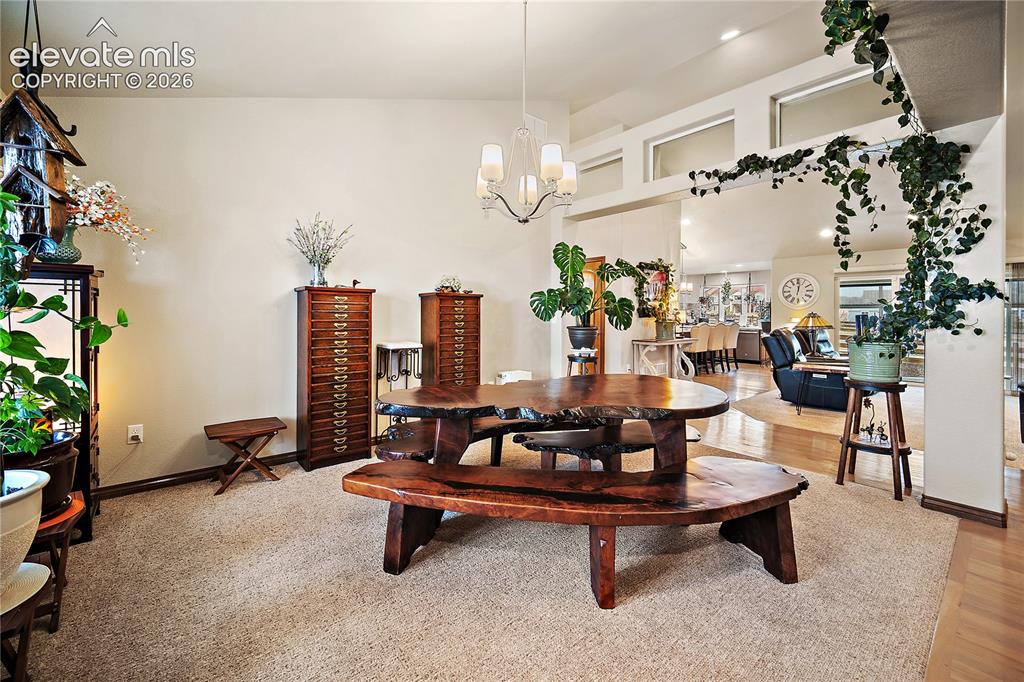 Image 4 of 44: Formal dining room with NEW carpet, vaulted ceiling and open to living room