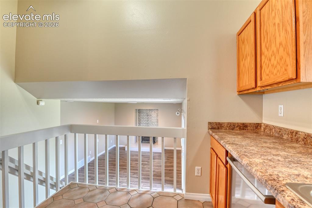 Image 12 of 50: Kitchen overlooking lower level family room.