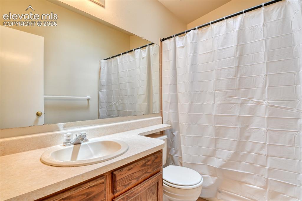 Image 32 of 50: Bathroom featuring a vanity with an integrated sink, laminate countertop, w