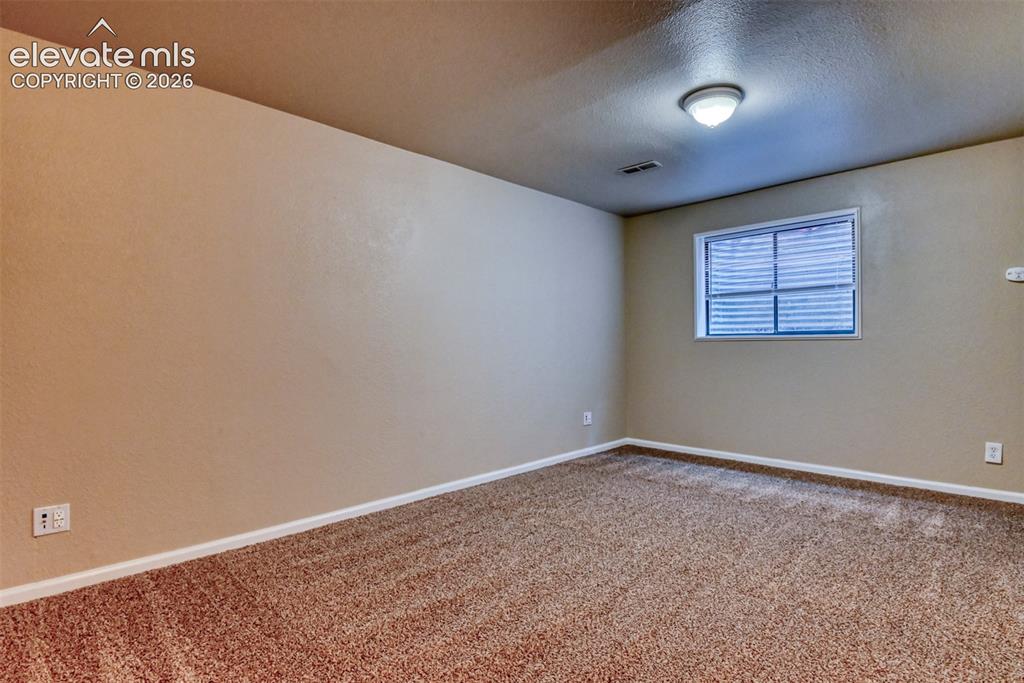 Image 34 of 50: Second family room/media room/ office. Carpeted room featuring a single win
