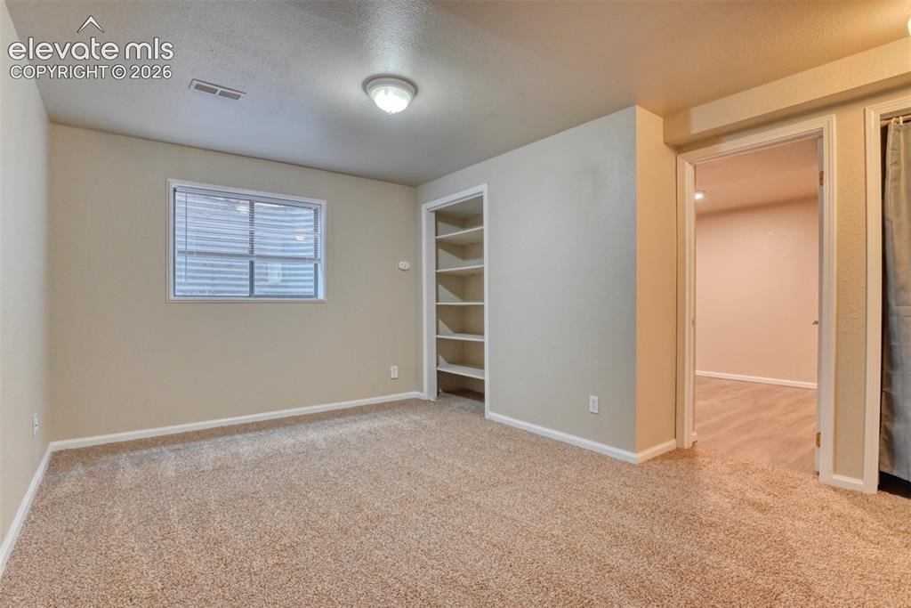Image 35 of 50: Second family room/media room/ office. Carpeted room featuring a single win