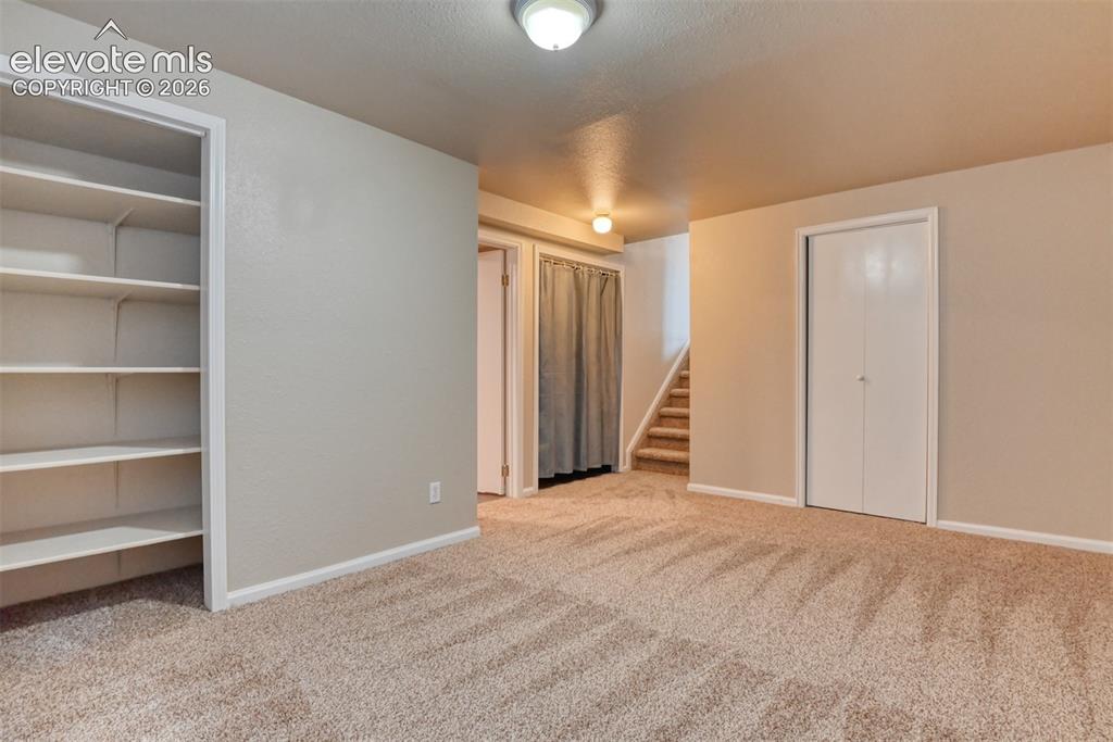 Image 36 of 50: Second family room/media room/ office. Carpeted room featuring a single win