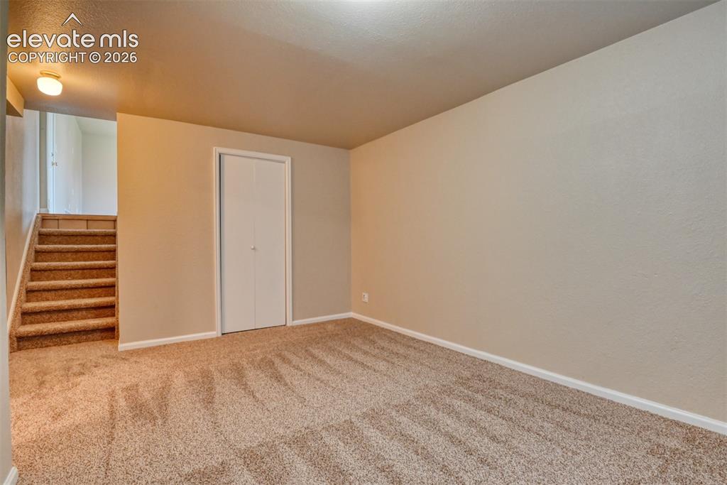 Image 37 of 50: Second family room/media room/ office. Carpeted room featuring a single win