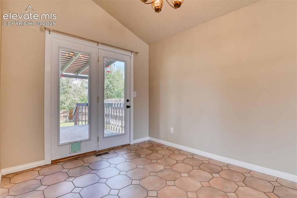 Image 6 of 50: Dining room with walk out to deck