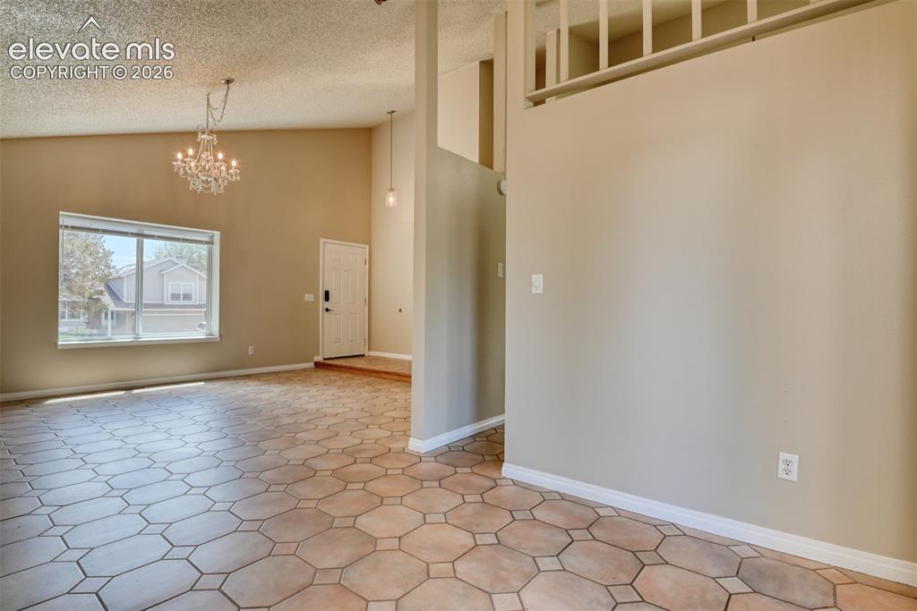 Image 8 of 50: Dining room open to living room.