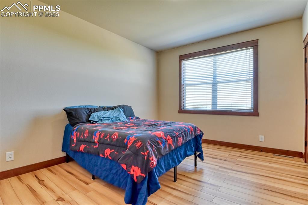 Image 19 of 47: Bedroom with LVT wood style floors