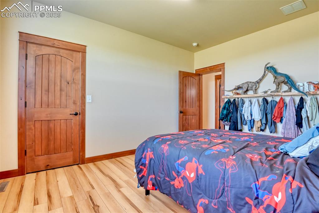 Image 20 of 47: Bedroom featuring wood finished floors and baseboards