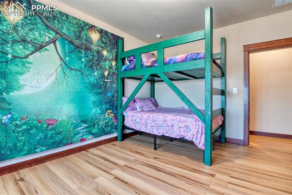 Image 21 of 47: Bedroom featuring LVT wood style floors 