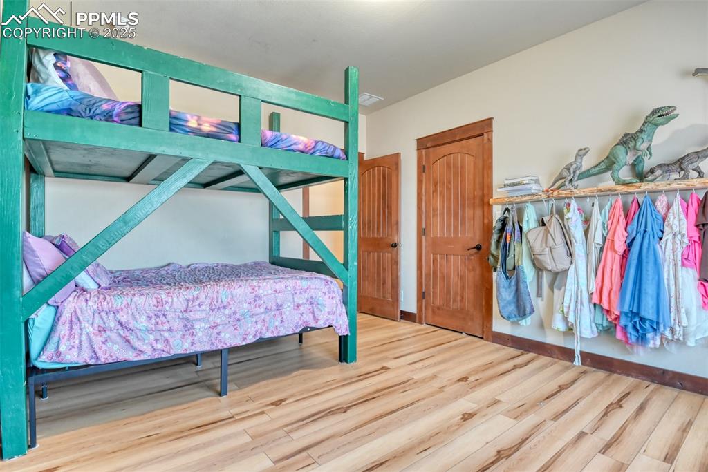Image 22 of 47: Bedroom featuring LVT wood style floors