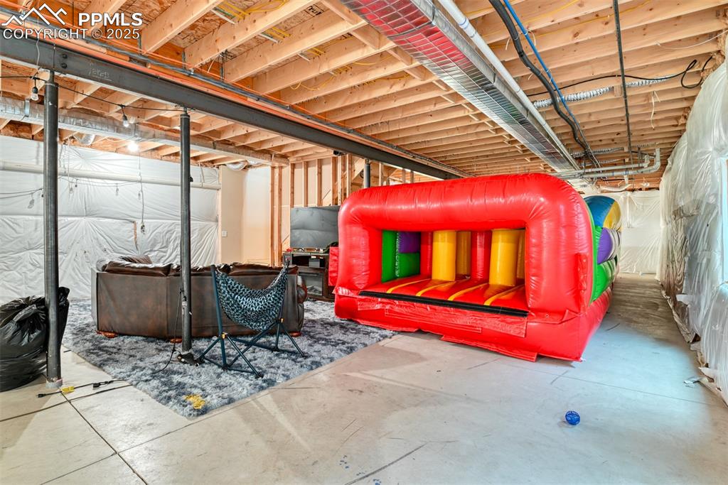 Image 28 of 47: View of unfinished basement included children