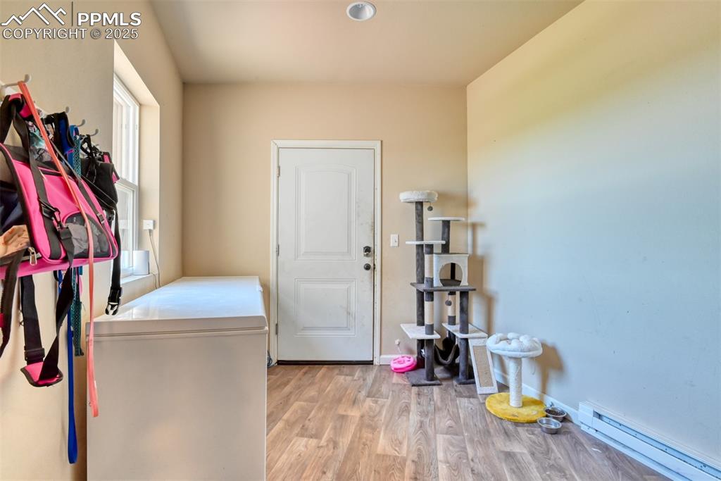 Image 29 of 47: Entry/Mud room featuring a baseboard radiator and LVT wood style flooring
