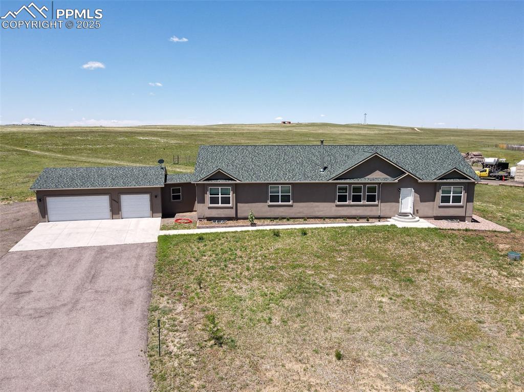 Image 34 of 47: Single story home with asphalt driveway, an attached garage, stucco siding,