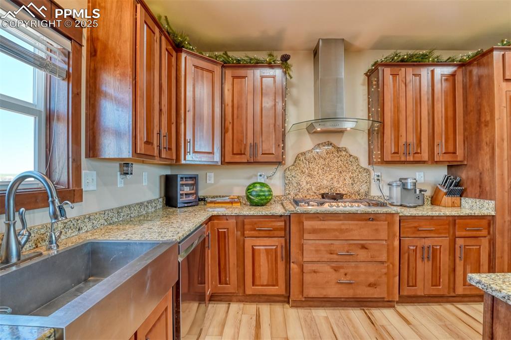 Image 5 of 47: Kitchen with wall chimney range hood, appliances with stainless steel finis