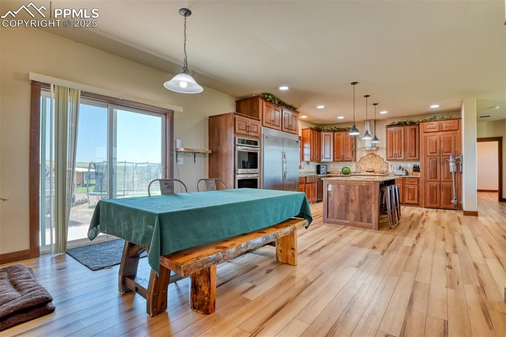 Image 9 of 47: Dining room featuring light wood finished floors and recessed lighting