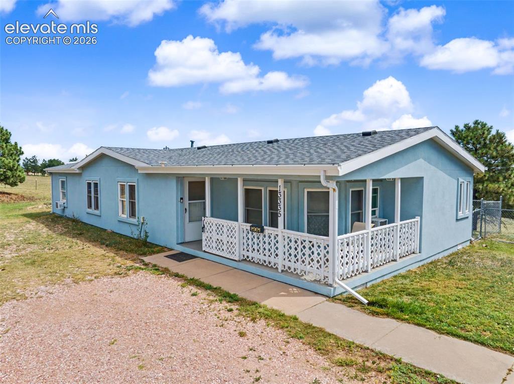 Image 1 of 38: Light blue exterior featuring white trim and a covered front porch with dec