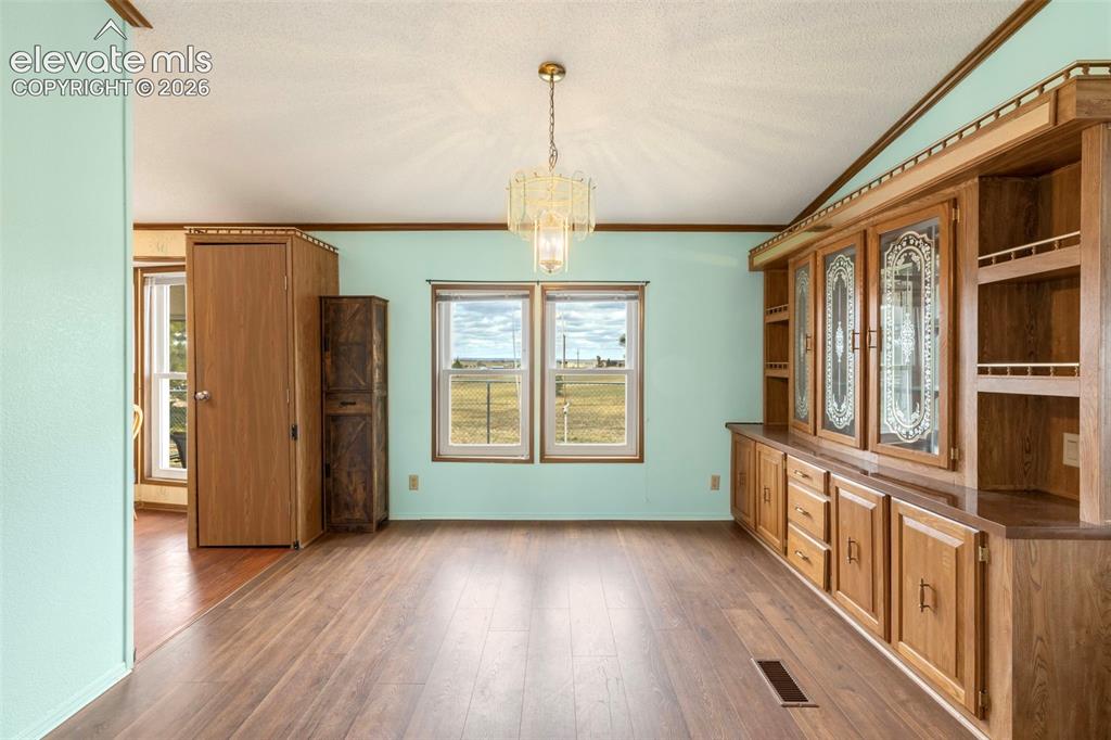 Image 10 of 38: Wood-finish flooring throughout