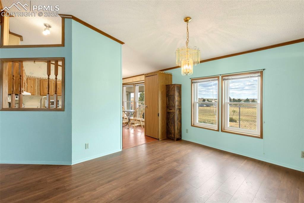 Image 17 of 38: Bright interior space featuring wood-finish flooring, light blue walls, and