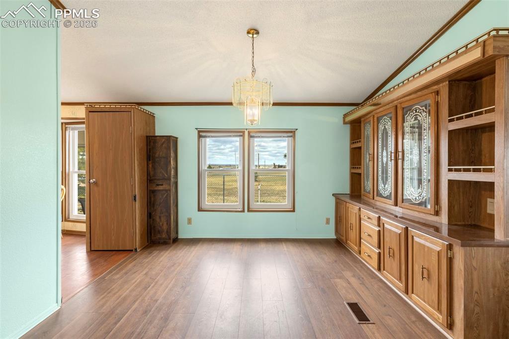 Image 18 of 38: Wood-finish flooring throughout